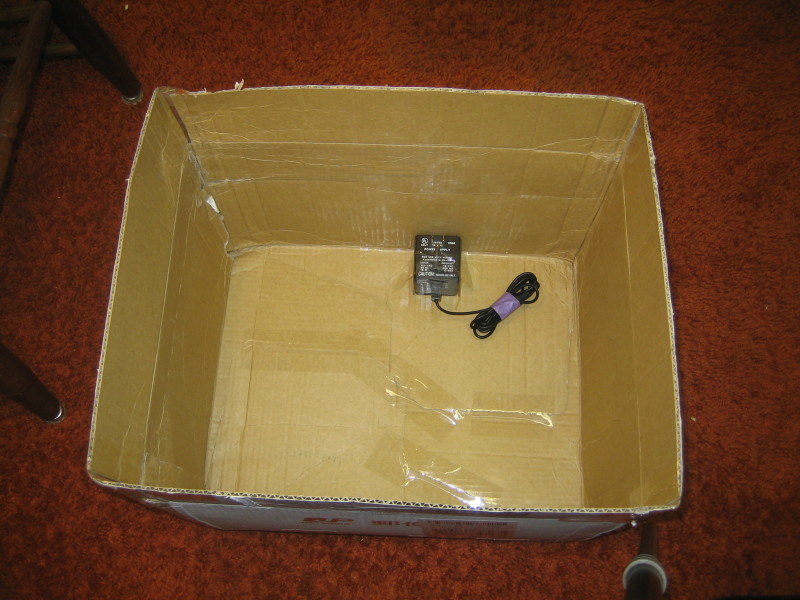 The box, with just the power adapter for lighting, carefully taped in place so it doesn't come loose in transit